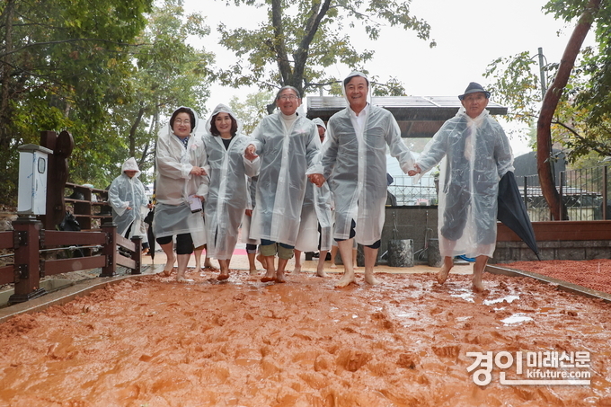 김성제 의왕시장(오른쪽 2번째)이 백운산 솔밭 황톳길을 맨발로 걷고 있다. <사진=의왕시>