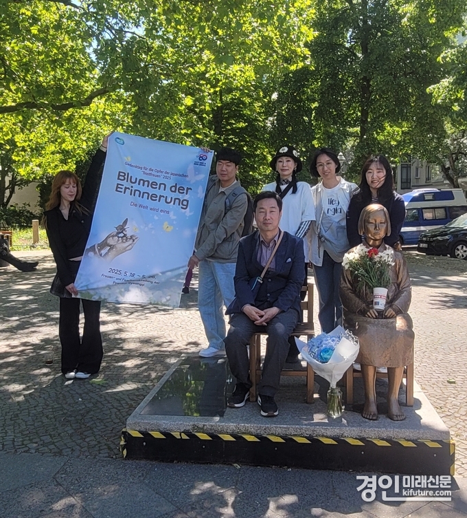경기도 관계자들이 베를린 소녀상에 꽃다발을 전달하고 기념촬영을 하고 있다. <사진=경기도>