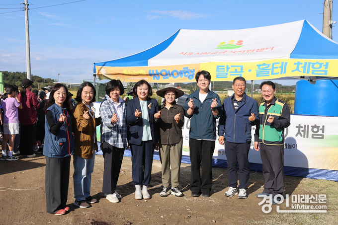 시흥시의회 교육복지위원회가 추수 체험 학습 현장에서 기념촬영을 하고 있다. <사진=시흥시의회>