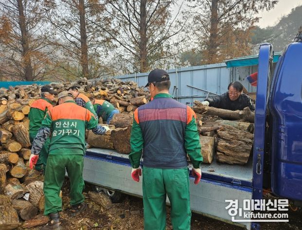 안산시관계자들이 땔감을 정리하고 있다. <사진=안산시>